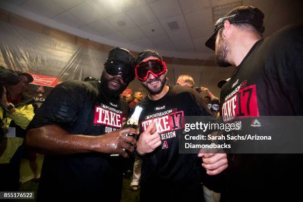 Fernando Rodney and Reymond Fuentes of the Arizona Diamondbacks celebrate in the locker room after defeating the Miami Marlins and clinching a...