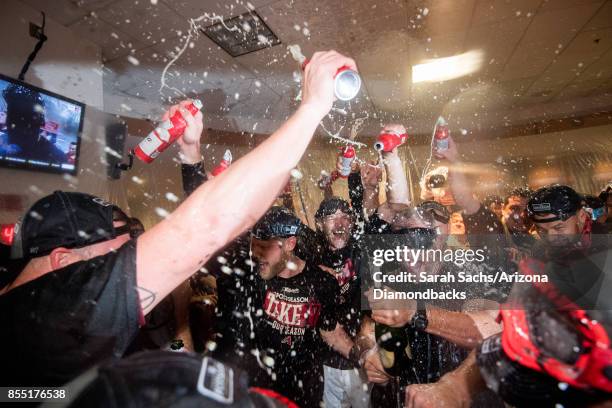 Jeremy Hazelbaker and Andrew Chafin of the Arizona Diamondbacks celebrate in the locker room after defeating the Miami Marlins and clinching a...