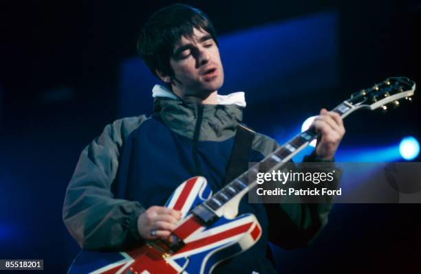 Photo of OASIS and Noel GALLAGHER, Noel Gallagher performing on stage, Union Jack Epiphone guitar
