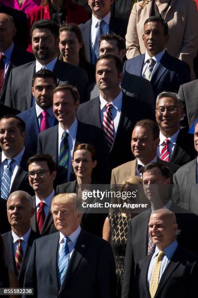 With National Security Advisor H.R. McMaster standing next to him , President Donald Trump poses for a group photo with members of the White House...