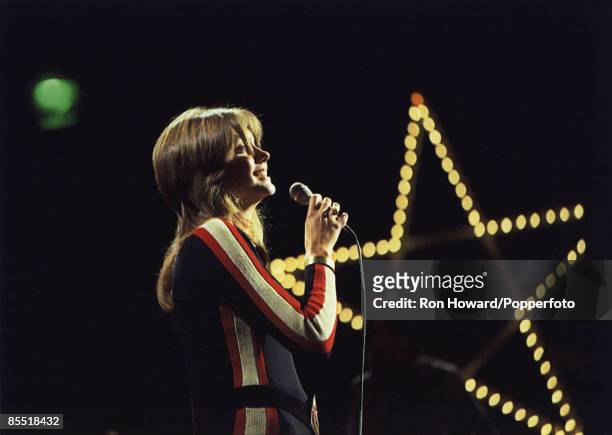 British singer Olivia Newton-John performs on the set of a pop music television show in London circa 1972.