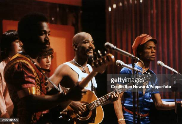 From left, Patrick Olive, Errol Brown and Tony Wilson of British soul group Hot Chocolate perform on the set of a pop music television show in London...