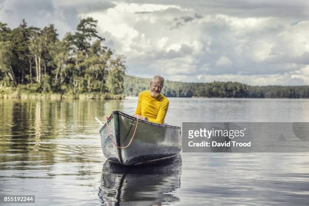 middle aged man in a canoe. - david trood stock-fotos und bilder