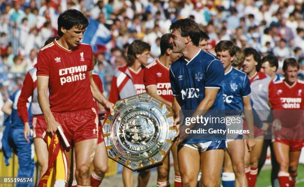 Liverpool captain Alan Hansen shares a joke with Everton captain Kevin Ratcliffe after the teams had shared the 1986 FA Charity shield after a 1-1...