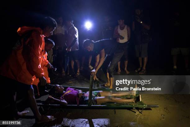 The body of a Rohingya woman is taken away after she washed up after a boat sunk in rough seas off the coast of Bangladesh carrying over 100 people...