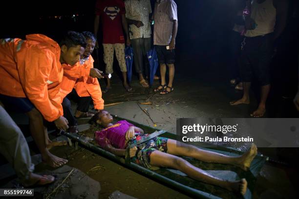 The body of a Rohingya woman is taken away after she washed up after a boat sunk in rough seas off the coast of Bangladesh carrying over 100 people...