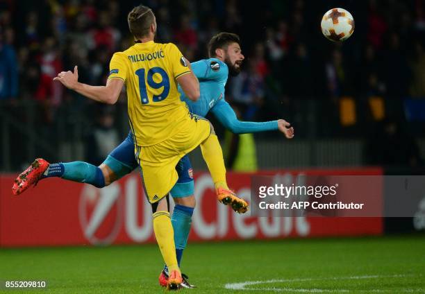 Borisov's defender from Serbia Nemanja Milunovic and Arsenal's forward from France Olivier Giroud vie for the ball during the UEFA Europa League...