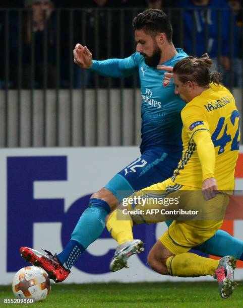 Arsenal's forward from France Olivier Giroud and BATE Borisov's defender from Belarus Maksim Valadzko vie for the ball during the UEFA Europa League...