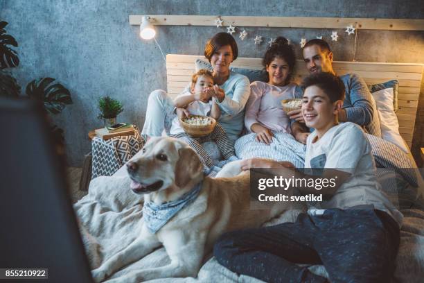 movie night is their favourite family tradition - get out film 2017 stock pictures, royalty-free photos & images