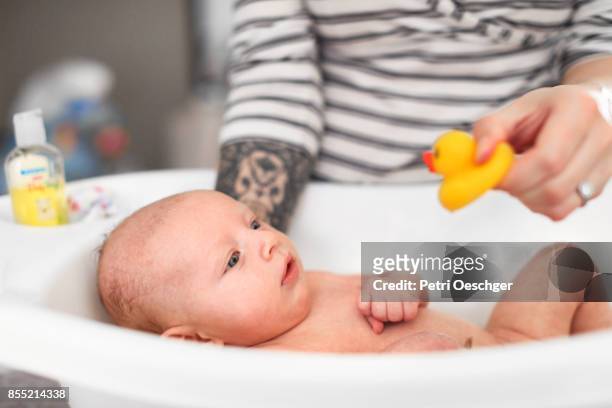 bath time. - baby bath toys stock pictures, royalty-free photos & images