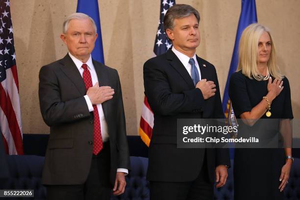 Attorney General Jeff Sessions, Federal Bureau of Investigation Director Christopher Wray and his wife Helen Wray stand for the national anthem...