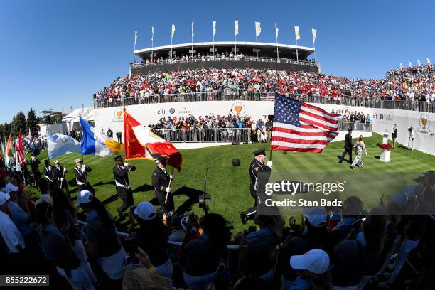 Cheryl Lee and Mark Lee, Jr., honoring Fire Captain Mark Lee Sr. Of Engine Co. 10, walk to the first tee during the trophy presentation at the start...