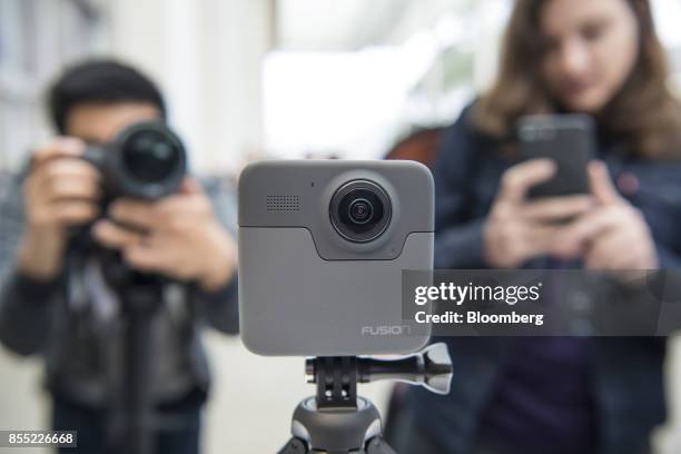 Attendees take photographs of the GoPro Inc. Fusion 360 camera during an event in San Francisco, California, U.S., on Thursday, Sept. 28, 2017....