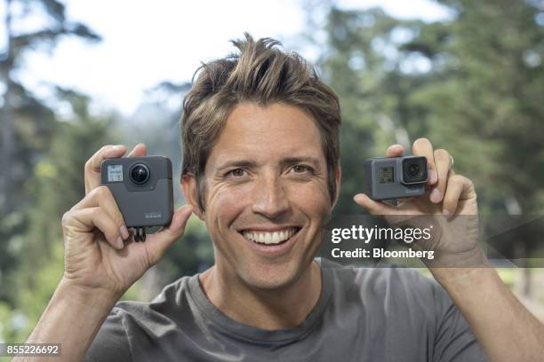 Nick Woodman, founder and chief executive officer of GoPro Inc., displays the Fusion 360, left, and the Hero 6 cameras while standing for a...