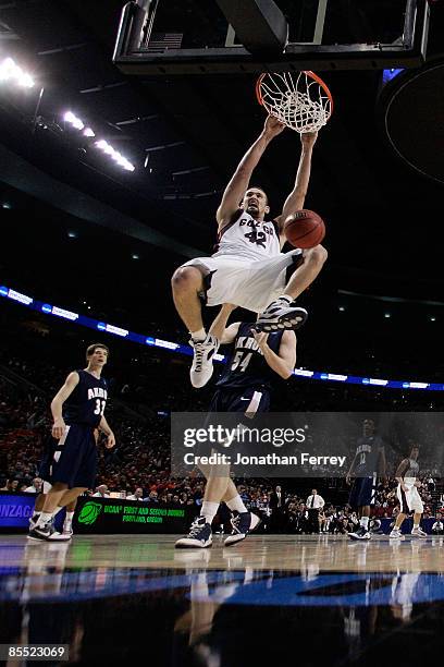 Josh Heytvelt of the Gonzaga Bulldogs dunks the ball in front of Mike Bardo of the Akron Zips in the second half during the first round of the NCAA...