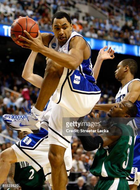 Gerald Henderson of the Duke Blue Devils grabs a rebound against Malik Alvin of the Binghamton Bearcats during the first round of the NCAA Division I...