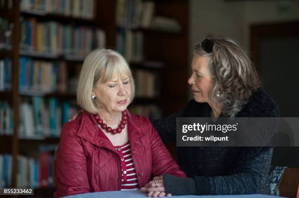 two senior ladies supporting and listening - old lady crying out for help stock pictures, royalty-free photos & images