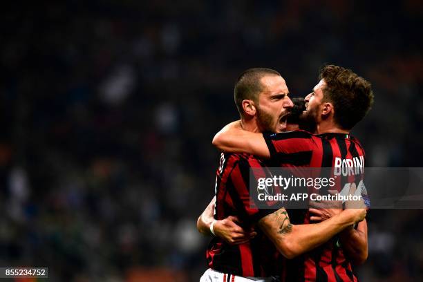 Milan's Argentinian defender Mateo Musacchio celebrates with teammates Leonardo Bonucci and Fabio Borini after scoring during the UEFA Europa League...