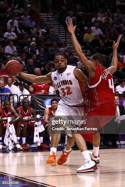 Demetri McCamey of the Illinois Fighting Illini drives on A.J. Slaughter in the first half during the first round of the NCAA Division I Men's...