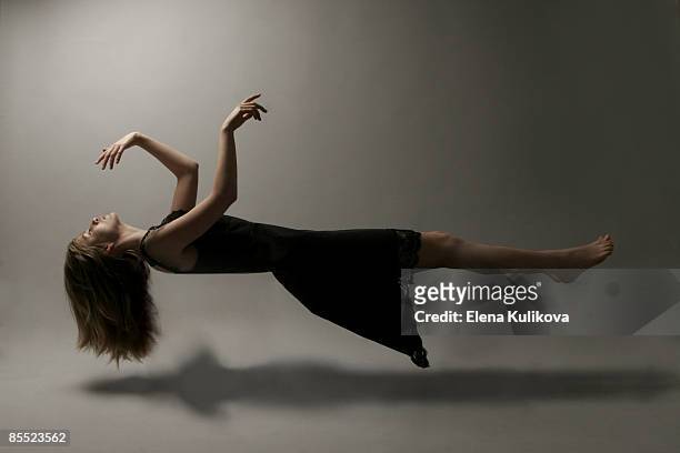 young woman in mid-air - levitation stock pictures, royalty-free photos & images
