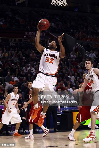 Demetri McCamey of the Illinois Fighting Illini goes up for a layup in the first half against the Western Kentucky Hilltoppers during the first round...
