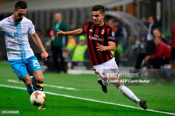 Milan's Portuguese forward Andre Silva vies with HNK Rijeka's Montenegrin midfielder Marko Vesovic during the UEFA Europa League football match AC...