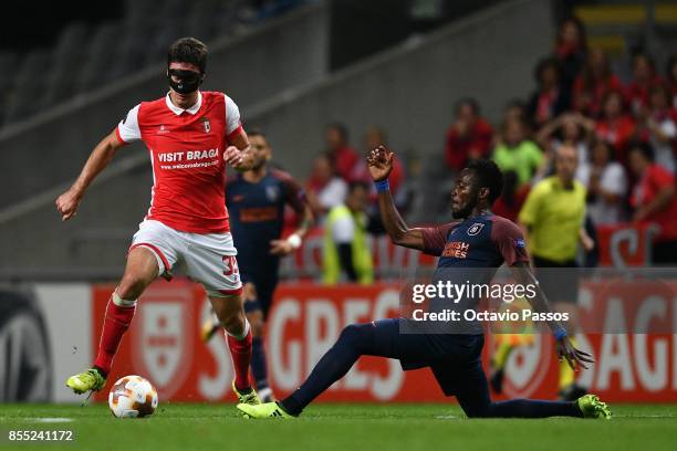 Nikola Vukcevic of Sporting Braga competes for the ball with Joseph Attamah of Basaksehir F.K. During the UEFA Europa League group C match between...