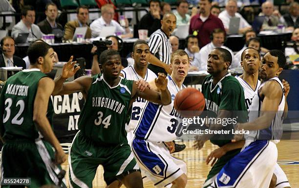 Jon Scheyer and Gerald Henderson of the Duke Blue Devils battle for a rebound against Chretien Lukusa and Reggie Fuller of the Binghamton Bearcats...