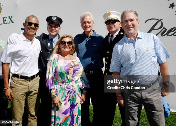 Cheryl Lee and Mark Lee Jr., honoring Fire Captain Mark Lee Sr., of Engine Company 10 pose with Former Presidents Barack Obama, Bill Clinton and...