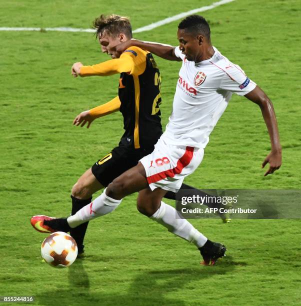 Skenderbeu's Bakary Nimaga vies for the ball with Young Boys' Michel Aebischer during the UEFA Europa League Group B football match between KF...