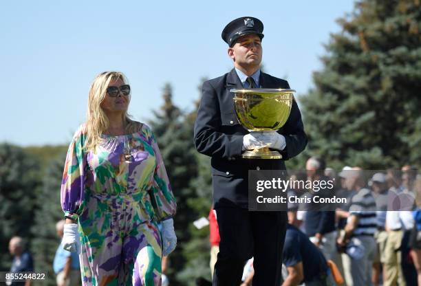 Cheryl Lee and Mark Lee Jr., honoring Fire Captain Mark Lee Sr., of Engine Company 10, walk to the first tee during the first round of the Presidents...