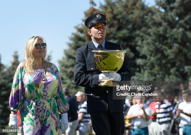 Cheryl Lee and Mark Lee Jr., honoring Fire Captain Mark Lee Sr., of Engine Company 10, walk to the first tee during the first round of the Presidents...