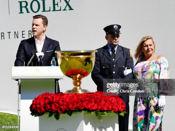 Cheryl Lee and Mark Lee Jr., honoring Fire Captain Mark Lee Sr., of Engine Company 10, walk to the first tee during the first round of the Presidents...