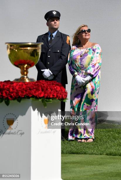 Cheryl Lee and Mark Lee Jr., honoring Fire Captain Mark Lee Sr., of Engine Company 10, walk to the first tee during the first round of the Presidents...