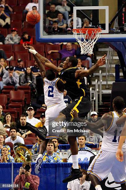 Darren Collison of the UCLA Bruins shoots against Larry Sanders of the VCU Rams during the first round of the NCAA Division I Men's Basketball...