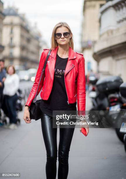 Model Kate Grigorieva wearing red leather jacket, black pants is seen outside Balmain during Paris Fashion Week Spring/Summer 2018 on September 28,...