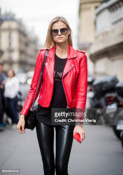 Model Kate Grigorieva wearing red leather jacket, black pants is seen outside Balmain during Paris Fashion Week Spring/Summer 2018 on September 28,...