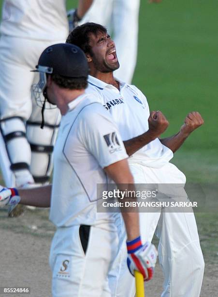 Indian cricketer Munaf Patel celebrates the wicket of New Zealand batsman Kyle Mills , during the third day of the first Test match between India and...