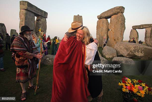 Druids watch the sunrise as they celebrate the Spring Equinox at Stonehenge on March 20 2009 near Amesbury, Wiltshire, England. Several hundred...