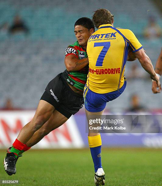 Brett Finch of the Eels is hit in a heavy tackle by Issac Luke of the Rabbitohs during the round two NRL match between the South Sydney Rabbitohs and...