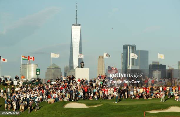 Jason Day of Australia and the International Team putts on the 18th green as he and Marc Leishman of Australia and the International Team play...