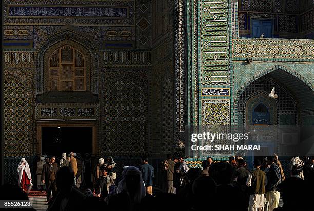 Afghan devotees walk at the Hazrat Ali Shrine in Mazar-i-Sharif on March 20, 2009. Tens of thousands of Afghans from all over the war-scarred country...