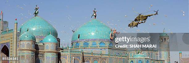 Helicopters fly over the Hazrat Ali Shrine in Mazar-i-Sharif on March 20, 2009. Tens of thousands of Afghans from all over the war-scarred country...