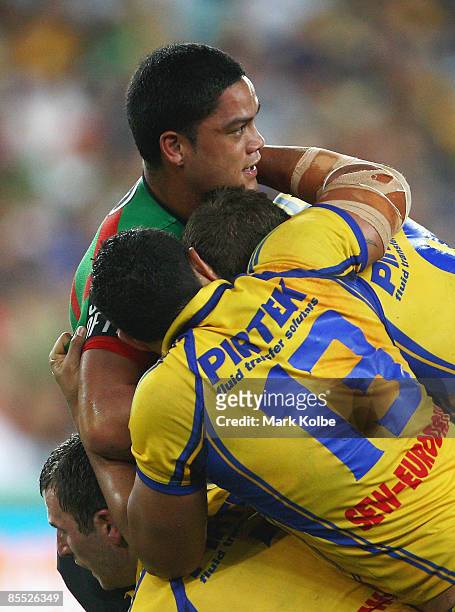 Issac Luke of the Rabbitohs is wrapped up by the Eels defence during the round two NRL match between the South Sydney Rabbitohs and the Parramatta...