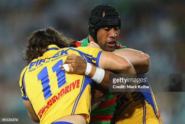 Roy Asotasi of the Rabbitohs is wrapped up by the defence during the round two NRL match between the South Sydney Rabbitohs and the Parramatta Eels...