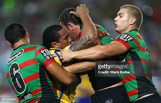 Fuifui Moimoi of the Eels is wrapped up by the Rabbitohs defence during the round two NRL match between the South Sydney Rabbitohs and the Parramatta...