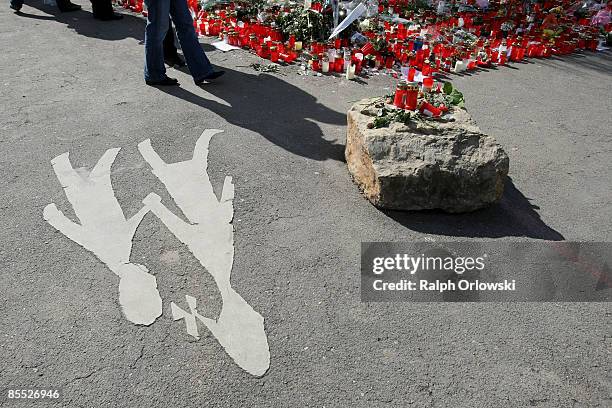 Mourners stand in front of candles outside the high school on March 20, 2009 in Winnenden near Stuttgart, Germany. 17 - year old Tim Kretschmer...