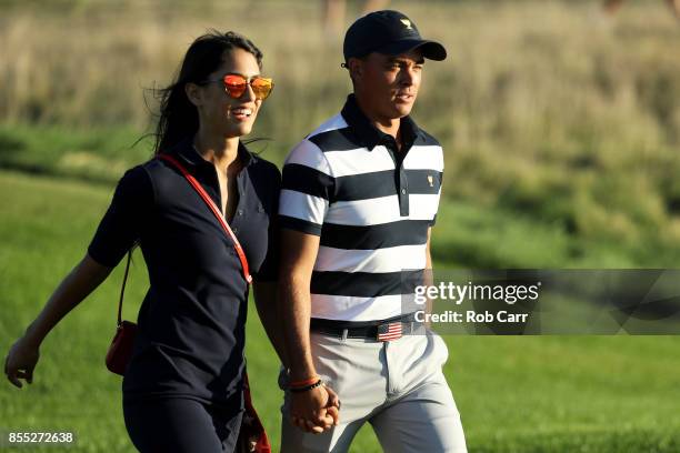 Rickie Fowler of the U.S. Team and girlfriend Allison Stokke walk on the 17th hole during Thursday foursome matches of the Presidents Cup at Liberty...
