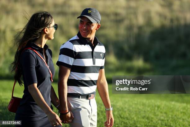 Rickie Fowler of the U.S. Team and girlfriend Allison Stokke walk on the 17th hole during Thursday foursome matches of the Presidents Cup at Liberty...