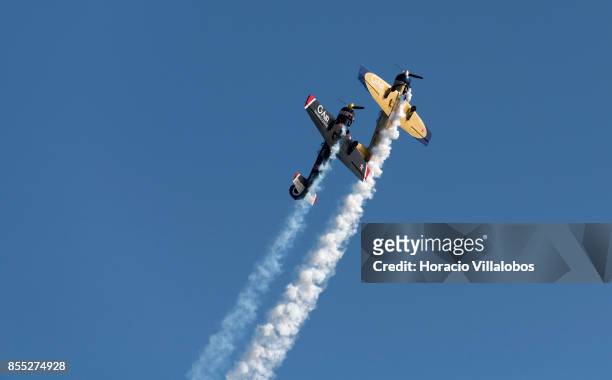 Two Yakovlev Yak-52 perform aerobatics over Tagus River during the commemoration of the 100th anniversary of Portuguese Naval Aviation on September...